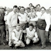 Members of the Ford football team show off a trophy.