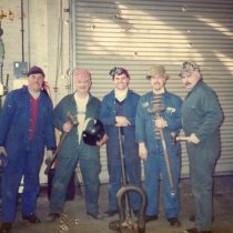 A group of five workers - Millwrights - pose for the camera in the Machine Shop 2012.
