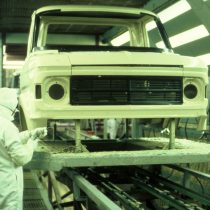 A worker in full protective suit works on Transit body in Paint Shop 2005