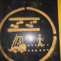 A hazard warning sign showing where people should walk in an area where fork lift trucks operate 2013.