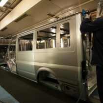 A worker sanding trim on a Transit body in the production line 2013.